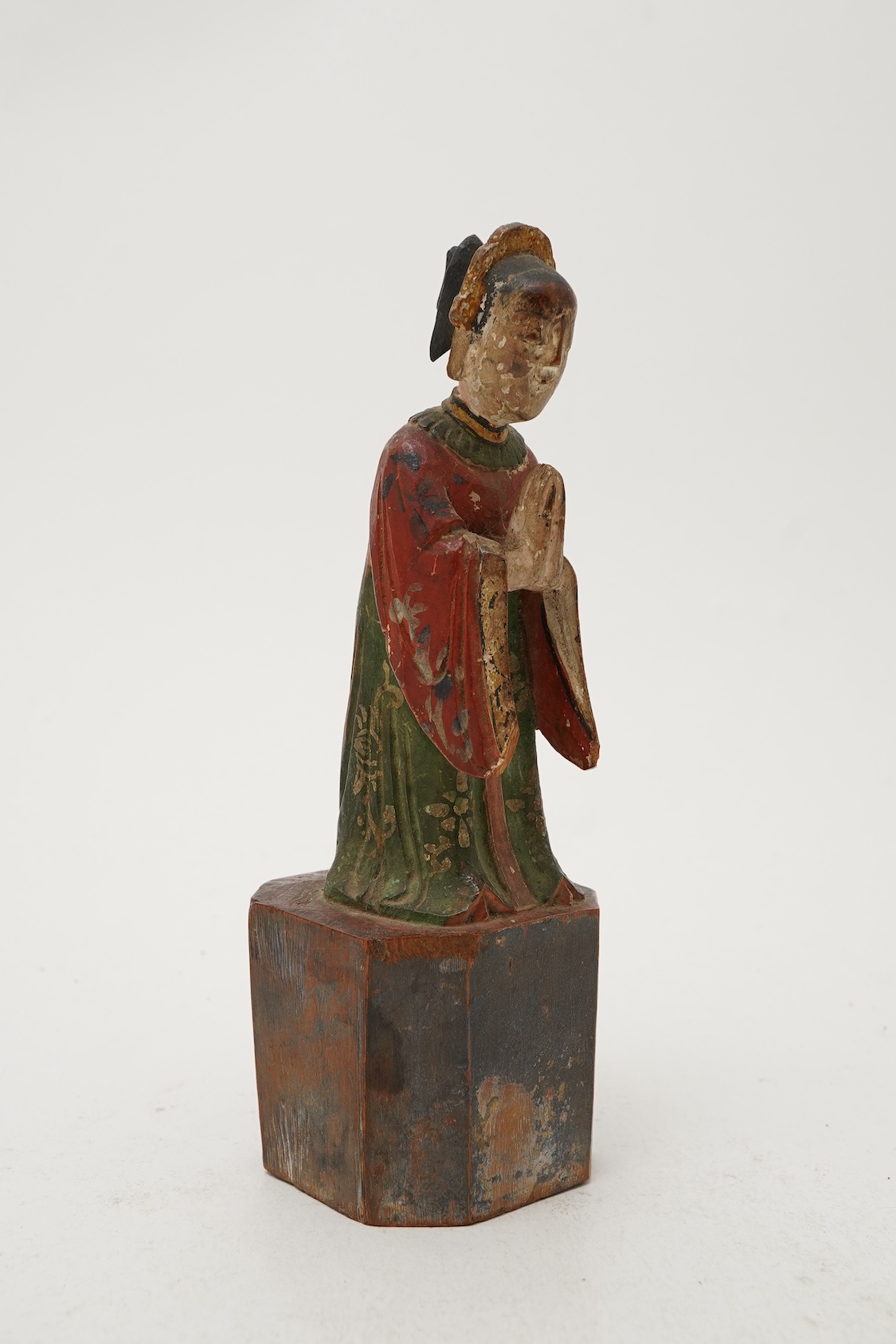 A Chinese polychrome wood figure of a female attendant, Qing dynasty